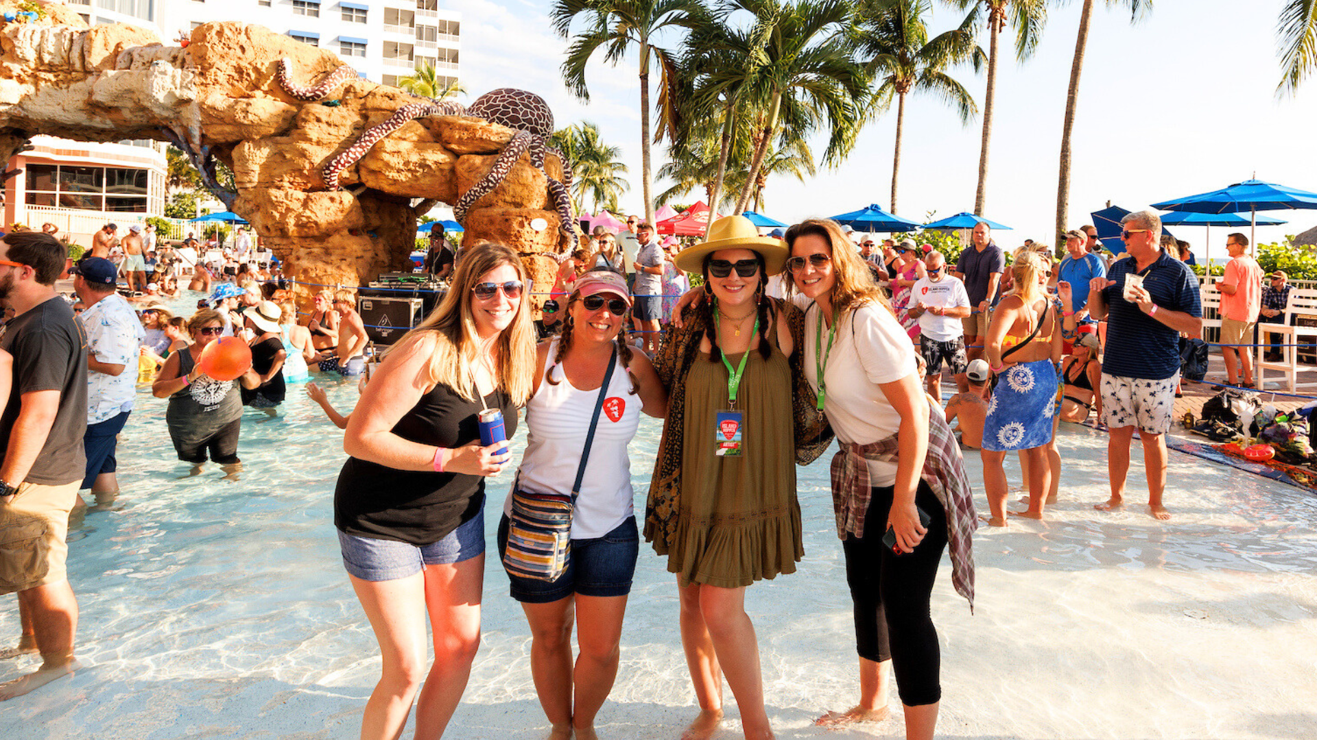 A group of friends celebrate at the Pink Shell Pool Party