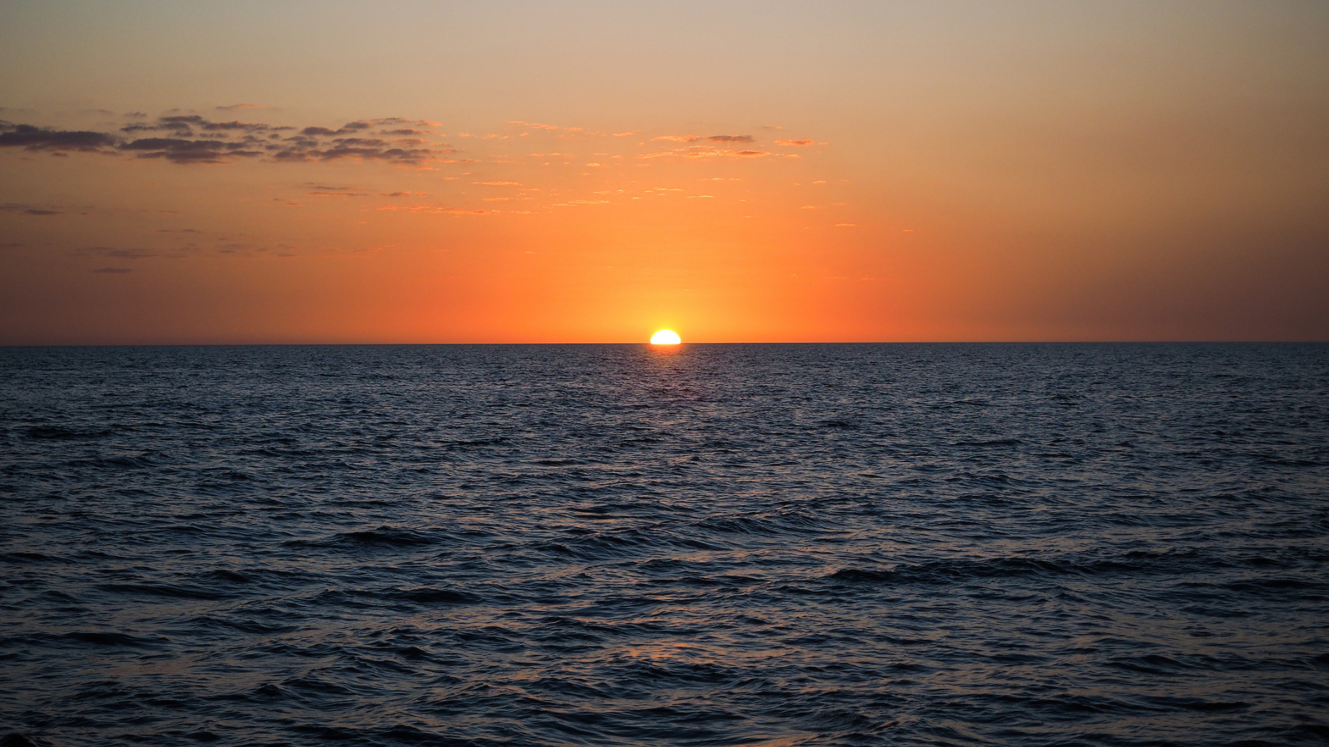 The sun sets over the water