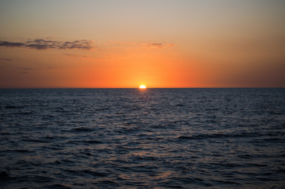 The sun sets over the water