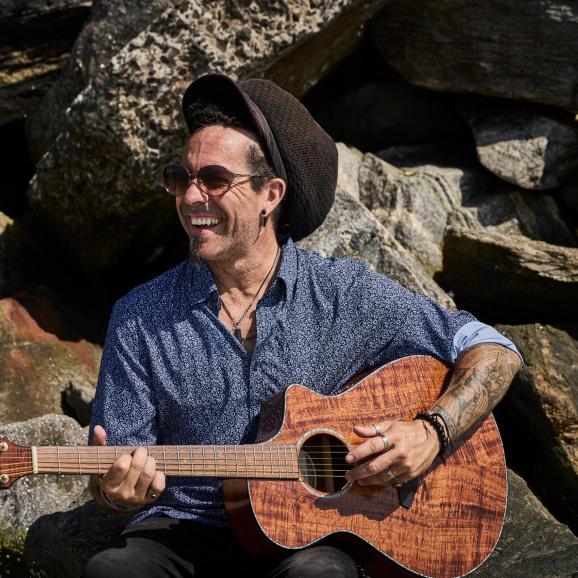 Image of Robinson with guitar