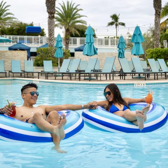 A couple enjoys the pool at 'Tween Waters Inn & Marina
